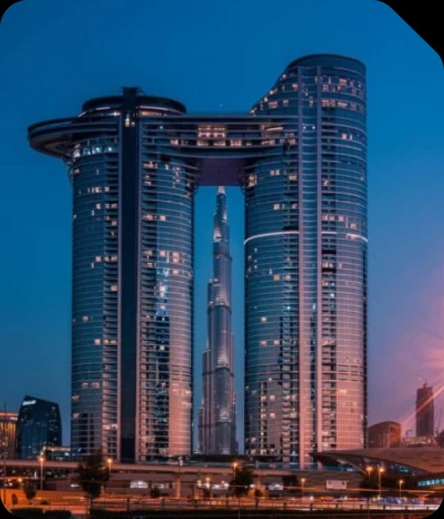 Address Sky View towers framing the Burj Khalifa at dusk